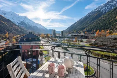 a balcony with a view of a city and mountains at Spacious flat in the centre of Chamonix in Chamonix-Mont-Blanc