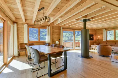 a dining room with a table and chairs at L'Eterle - Grand chalet avec terrasse et jardin in Les Contamines-Montjoie