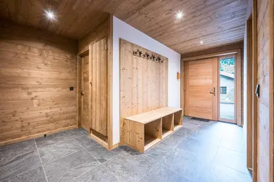 a room with a wooden wall and a bench at L'Eterle - Grand chalet avec terrasse et jardin in Les Contamines-Montjoie
