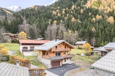 an aerial view of a wooden house in a mountain at L'Eterle - Grand chalet avec terrasse et jardin in Les Contamines-Montjoie