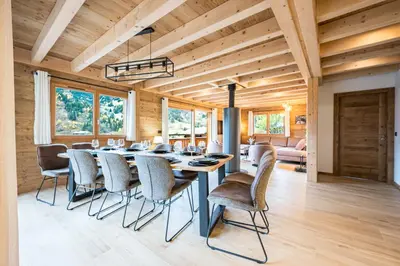 a dining room with a table and chairs at L'Eterle - Grand chalet avec terrasse et jardin in Les Contamines-Montjoie