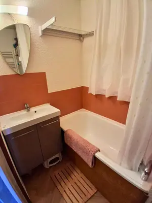 a bed in a room with a white mattress at Studio SnowCarroz with a view for 4 people in Arâches-la-Frasse