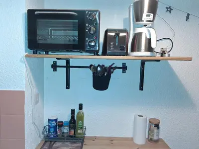 a microwave and a toaster oven on a shelf at Studio SnowCarroz with a view for 4 people in Arâches-la-Frasse