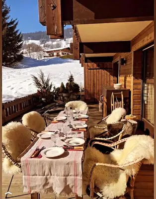 a group of chairs around a table in the snow at Cimes Lodge - Wood & Mountain in Demi-Quartier