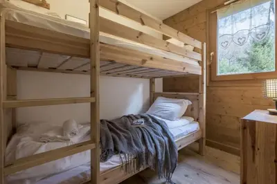 a bedroom with two bunk beds and a window at Capucins in Chamonix-Mont-Blanc
