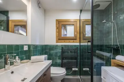 a bathroom with a toilet and a glass shower at Capucins in Chamonix-Mont-Blanc