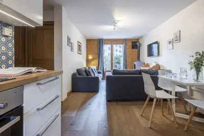 a kitchen and living room with a couch and a table at Capucins in Chamonix-Mont-Blanc