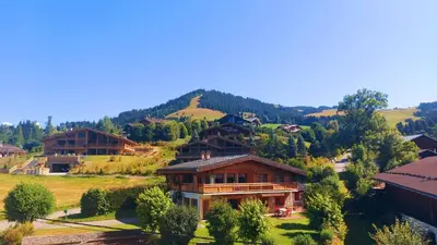 a group of houses on a hill with trees at Appartement Mont d'Arbois in Megève