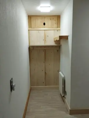 a room with a wooden table and a shelf at Appartement Mont d'Arbois in Megève