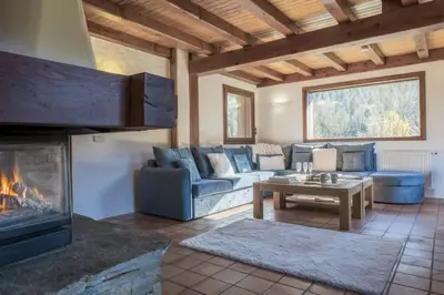 a living room with a couch and a fireplace at Chalet Cusco in Servoz