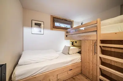 a small bedroom with a bunk bed and a ladder at Apartment Snowdust Megève - by EMERALD STAY in Megève