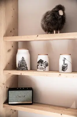 a shelf with vases and a clock on it at Apartment Snowdust Megève - by EMERALD STAY in Megève
