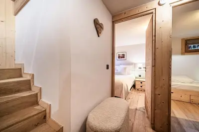 a bedroom with a stairway leading to a bedroom at Apartment Snowdust Megève - by EMERALD STAY in Megève
