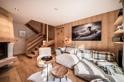 a living room with a couch and a staircase at Apartment Snowdust Megève - by EMERALD STAY in Megève