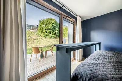 a bedroom with a bed and a large window at Apartment Spritz Megève - by EMERALD STAY in Megève