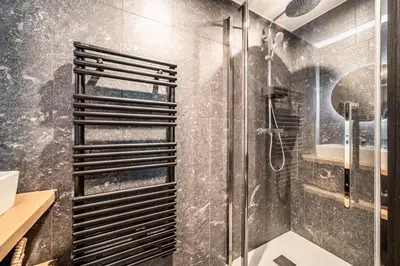 a bathroom with a shower with a glass door at Apartment Spritz Megève - by EMERALD STAY in Megève