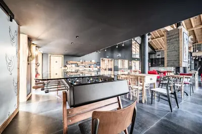 a restaurant with a ping pong table and chairs at Apartment Spritz Megève - by EMERALD STAY in Megève