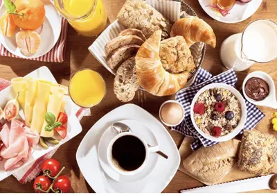 a table full of breakfast foods and coffee on a table at Apartment Spritz Megève - by EMERALD STAY in Megève