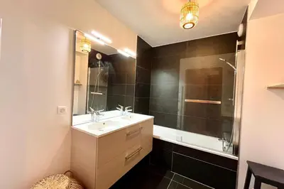 a bathroom with a sink and a shower and a mirror at Bright apartment with balcony and stunning views in Megève