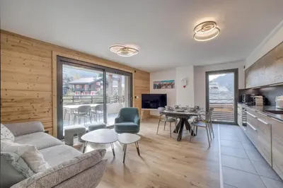 a living room with a couch and a table at Cosmiques A203 - New & Mont Blanc view in Les Houches
