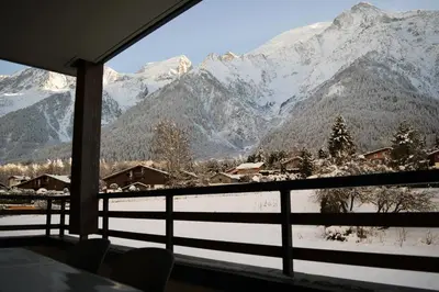a view of a snowy mountain range from a window at Cosmiques A203 - New & Mont Blanc view in Les Houches