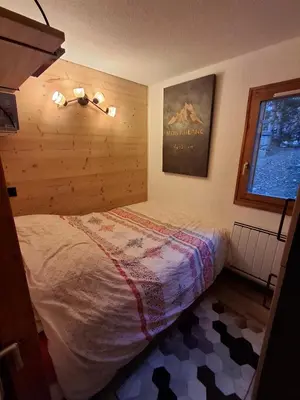 a bedroom with a bed and a window at Armancette B7 in Les Contamines-Montjoie