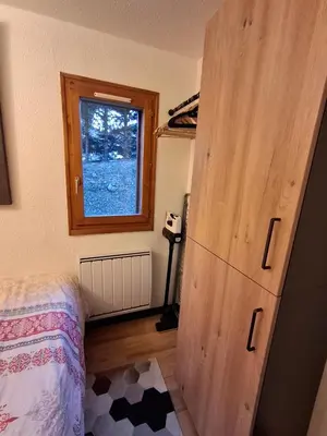 a bedroom with a wooden closet and a bed at Armancette B7 in Les Contamines-Montjoie