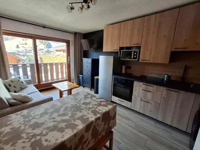 a kitchen with a couch and a table in a room at Armancette B7 in Les Contamines-Montjoie