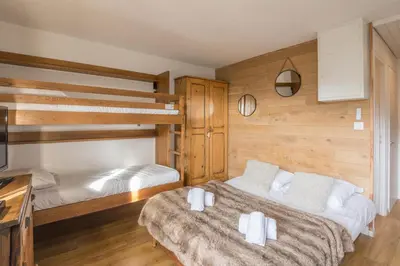 a bedroom with two beds and a bunk bed at Studio Espérance - Welkeys in Megève