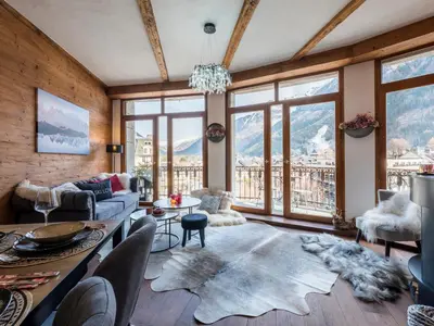 a living room with a couch and a table at Diamond - Hyper Central 2 Bedrooms - Magnificent Views - By Cozee Rentals in Chamonix-Mont-Blanc