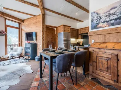 a kitchen with a table and chairs in a room at Diamond - Hyper Central 2 Bedrooms - Magnificent Views - By Cozee Rentals in Chamonix-Mont-Blanc