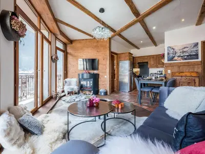 a living room with a couch and a table at Diamond - Hyper Central 2 Bedrooms - Magnificent Views - By Cozee Rentals in Chamonix-Mont-Blanc