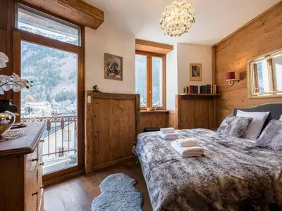 a bedroom with a bed and a large window at Diamond - Hyper Central 2 Bedrooms - Magnificent Views - By Cozee Rentals in Chamonix-Mont-Blanc