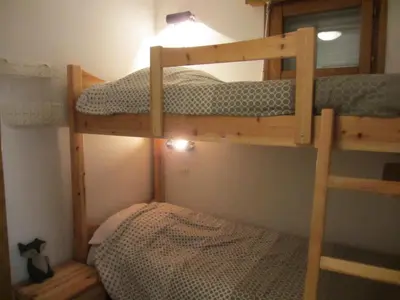 a bedroom with two bunk beds and a bed at Résidence L'enclave - Enclave I599 MAE-9743 in Les Contamines-Montjoie