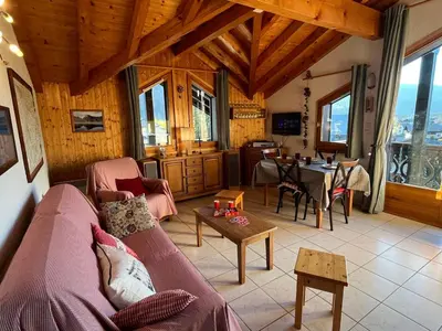 a living room with a couch and a table at Confortable T3 au cœur de Samoëns avec WIFI et parking - FR-1-629-152 in Samoëns
