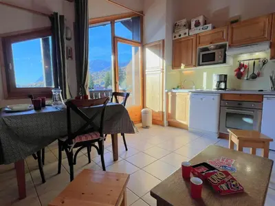 a kitchen and dining room with a table and a dining room at Confortable T3 au cœur de Samoëns avec WIFI et parking - FR-1-629-152 in Samoëns