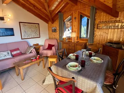 a living room with a table and a couch at Confortable T3 au cœur de Samoëns avec WIFI et parking - FR-1-629-152 in Samoëns