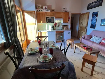 a kitchen and living room with a table and chairs at Confortable T3 au cœur de Samoëns avec WIFI et parking - FR-1-629-152 in Samoëns