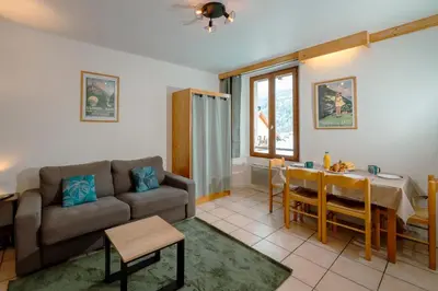 a living room with a couch and a table at Refuge des Cols Verts Parking Cozy Relaxing in Saint-Gervais-les-Bains
