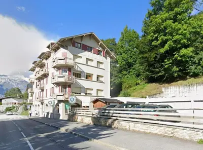 a large white building on the side of a street at Refuge des Cols Verts Parking Cozy Relaxing in Saint-Gervais-les-Bains