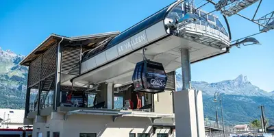 a tram stop with a mountain in the background at Refuge des Cols Verts Parking Cozy Relaxing in Saint-Gervais-les-Bains