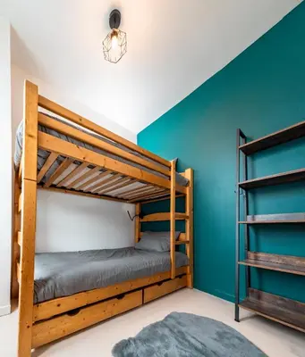 two bunk beds in a room with blue walls at Refuge des Cols Verts Parking Cozy Relaxing in Saint-Gervais-les-Bains