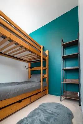 a bedroom with two bunk beds and a ladder at Refuge des Cols Verts Parking Cozy Relaxing in Saint-Gervais-les-Bains