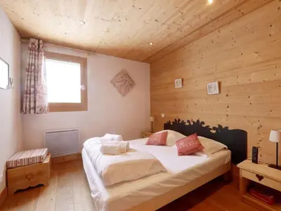 a bedroom with a large bed in a wooden room at Spacieux appartement 96 m² à Flaine Hameau avec piscine et parking - FR-1-687-119 in Arâches-la-Frasse