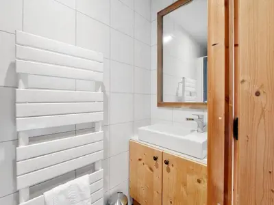 a white bathroom with a sink and a mirror at Spacieux appartement 96 m² à Flaine Hameau avec piscine et parking - FR-1-687-119 in Arâches-la-Frasse