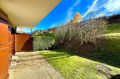 a walkway leading to a yard with a fence at Bright apartment in Combloux near ski in Combloux