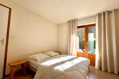 a bedroom with a bed and a window at Bright apartment in Combloux near ski in Combloux