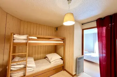 a bunk bed room with two bunk beds in it at Bright apartment in Combloux near ski in Combloux