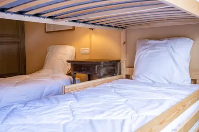 two bunk beds in a room with a desk at Spacious Apartment 4BR 10P Megève Center in Megève