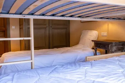 a bedroom with two bunk beds and a table at Spacious Apartment 4BR 10P Megève Center in Megève